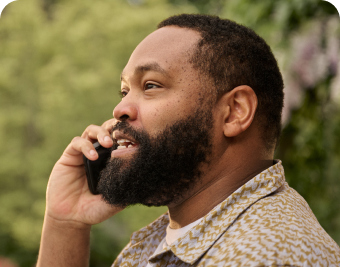 Man with COVID on the phone outside contacting a healthcare professional