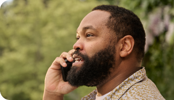 Man with COVID on the phone outside contacting a healthcare professional