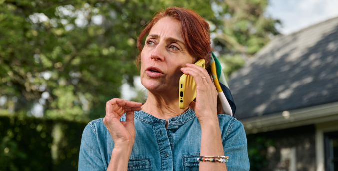 Woman with COVID speaking on the phone outside